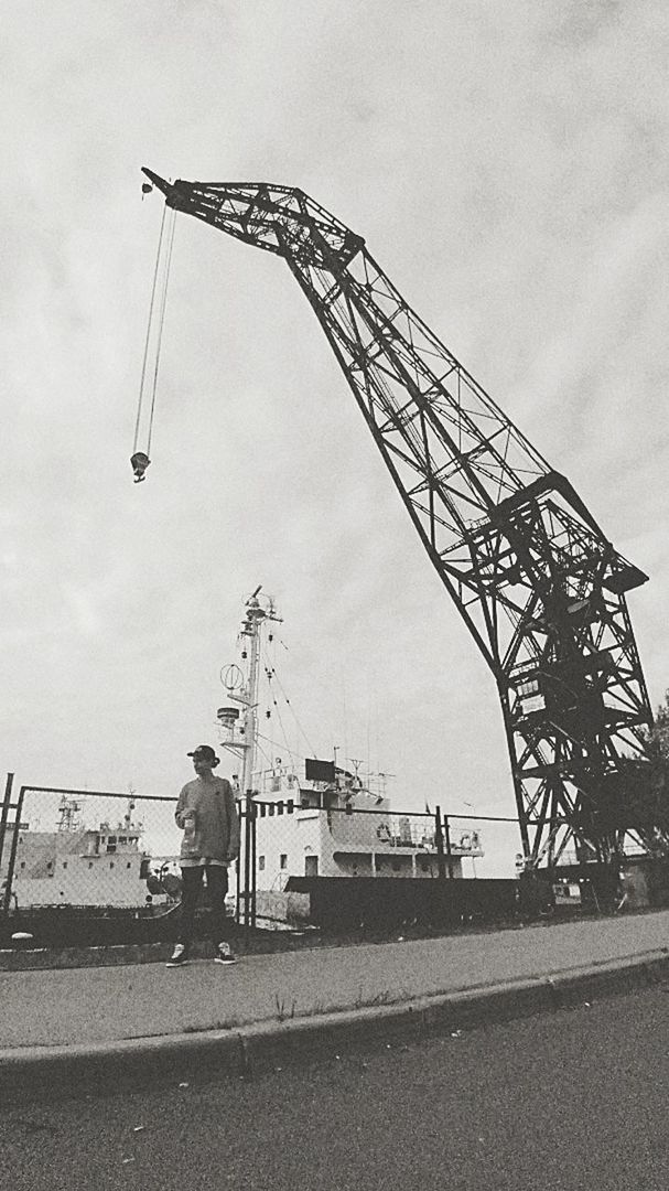 machinery, construction industry, sky, crane - construction machinery, industry, architecture, development, construction site, nature, real people, built structure, day, men, transportation, cloud - sky, outdoors, one person, construction machinery, building exterior, construction equipment