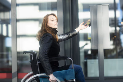Young woman in wheelchair in the city