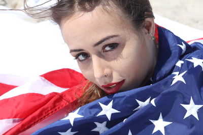 Close-up portrait of young woman wearing american flag