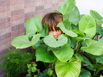 Portrait of smiling woman amidst plants