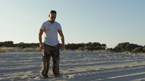 Man on the beach as a concept of freedom and strength