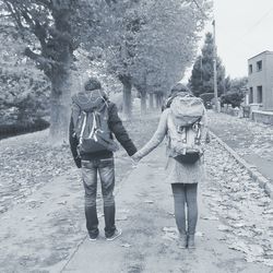 Full length of woman walking with umbrella