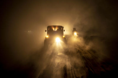 Illuminated car against sky at night