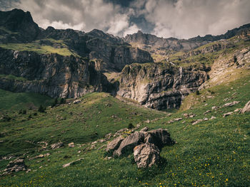 Scenic view of land and mountains against sky