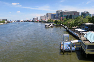 High angle view of buildings by river against sky