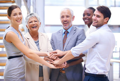 Business colleagues stacking hands