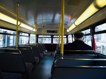 Rear view of man sitting in train