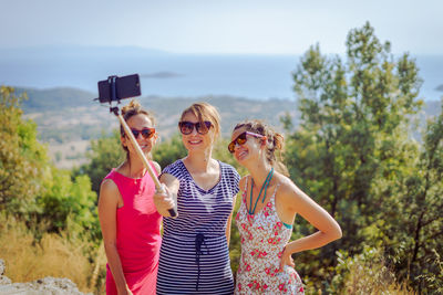 Female friends taking selfie on mountain