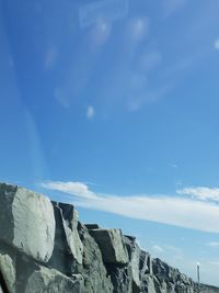 Low angle view of rock formation against sky