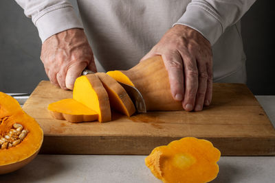 Midsection of man preparing food on table