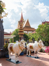 View of sculptures outside temple against building