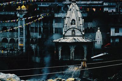 Buildings and temple in city at night