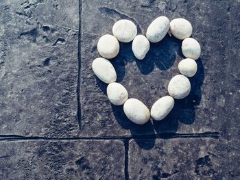 High angle view of heart shape stone on rock