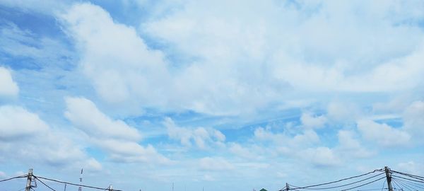 Low angle view of telephone pole against sky