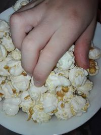 Close-up of hand holding ice cream in bowl