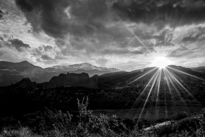 Scenic view of mountains against cloudy sky