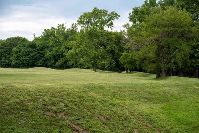 Native american hopewell culture grass covered burial mound cluster in mound city ohio