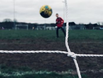 View of man playing with rope on field