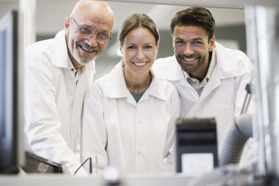 Portrait of happy engineers working in manufacturing plant