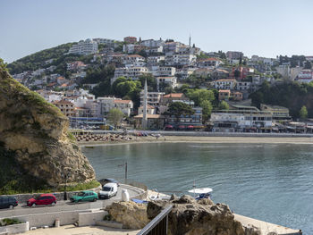 Townscape by sea against sky in city