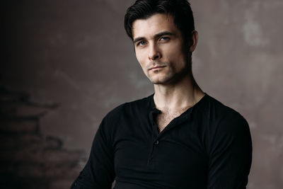 Portrait of young man standing outdoors