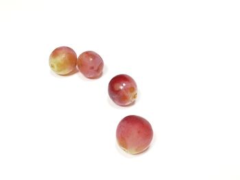 Close-up of fruits over white background