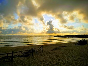 Scenic view of beach against sky during sunset