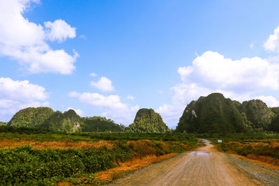 Empty road along countryside landscape