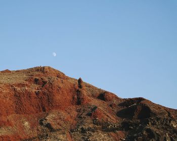 Low angle view of mountain against blue sky