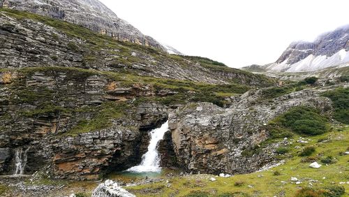 Scenic view of waterfall against sky