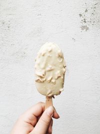 Close-up of hand holding ice cream cone