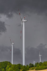 Low angle view of windmill against sky