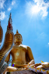 Low angle view of statue against temple against sky