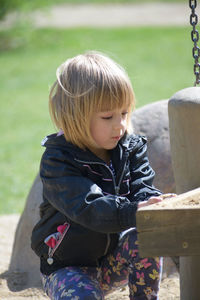 Cute girl crouching in park