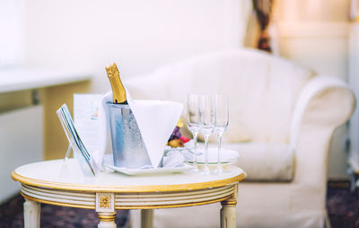 Close-up of champagne bottle on table in hotel room