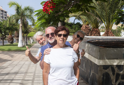 Portrait of senior people standing at park