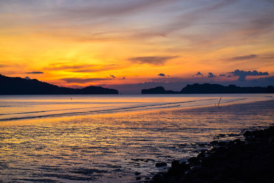 Scenic view of sea against orange sky