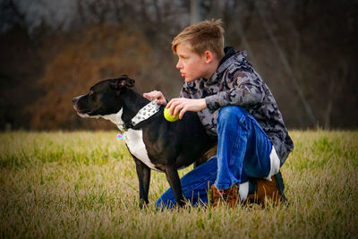 Portrait of young teenage boy and his dog