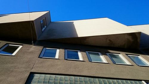 Low angle view of building against clear blue sky