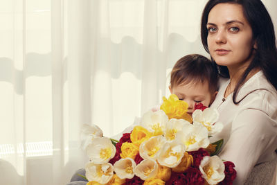 Portrait of young woman with bouquet