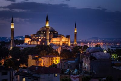 Illuminated hagia sophia against cloudy sky at dusk in city