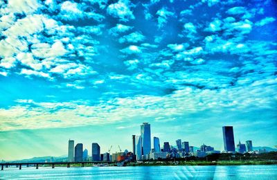 Cityscape against cloudy sky