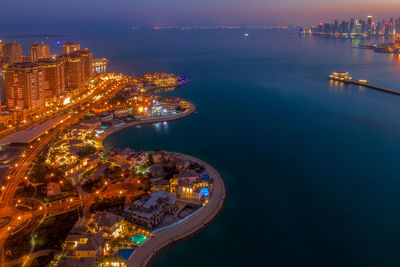 High angle view of illuminated city buildings at night