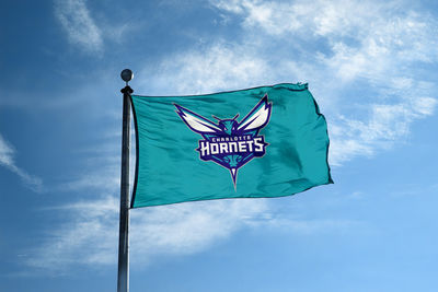 Low angle view of flag against blue sky