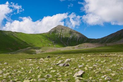 Scenic view of green mountains against sky