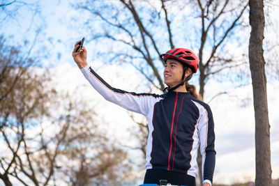 Male athlete taking selfie while standing park