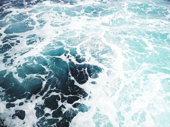 High angle view of water splashing on beach