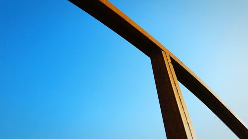 Low angle view of bridge against clear blue sky