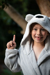 Portrait of boy pointing while standing outdoors