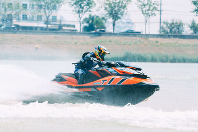 Side view of a man riding boat in water